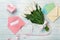 A bouquet of white tulips and a pink ribbon in the form of a heart with a gift box, love note and color envelope on blue