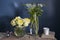 A bouquet of white veronica in a tall narrow vase on a grey table on the white background