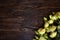 A bouquet of white and yellow French roses on a vintage, wooden background