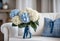 Bouquet of whitw and blue hydrangeas in vase on table in living room.
