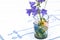 Bouquet of wild flower bellflower campanula  in a glass vase on an embroidered tablecloth, home decoration concept