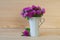 Bouquet of wild flowers clover in a cup on a wooden background