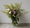 Bouquet of wild flowers in a glass jug