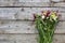 Bouquet of wildflowers lies on the old wooden background