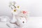 Bouquet of wildflowers white cosmos or cosmea in white vase, gift, white ceramic candlestick in the shape of apple