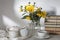 A bouquet of yellow jerusalem artichoke in a transparent vase on against white background on the table