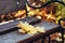 Bouquet of yellow maple leaves on city park bench. Selective focus, autumn mood background