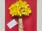 Bouquet of yellow spring flowers. Bunch narcissus packed craft paper with greeting card.Spring card for Mother`s Day