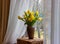 Bouquet of yellow tulips and daffodils  in a vase. Easter and spring greeting card. Women`s day, March 8