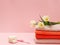 Bouquet of yellow tulips with towels on a pink background