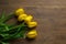 bouquet of yellow tulips tulips on a wooden background. March 8. March. Spring. women\'s holiday. mom\'s holiday. spring flowers