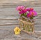 Bouquet zinnias next to a decorative starling house