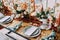 Bouquets of flowers stand on the table next to the festive menu on plates