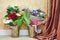 Bouquets of flowers in two metal buckets stand on floor