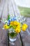 Bouquets of flowers with umbrella inflorescences of Lily of the valley, wild onion, Ranunculus acris, meadow Buttercup and blue