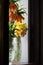 Bouquets of yellow daffodils and Imperial grouse in window openi