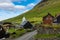 Bour village. Typical grass-roof houses and green mountains. Vagar island, Faroe Islands. Denmark. Europe