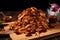 bourbon bbq sauce-drenched pulled chicken pile on wooden board