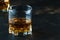 Bourbon in glass, american corn whiskey, dark bar counter, selective focus