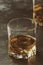 Bourbon in glass, american corn whiskey, dark bar counter, selective focus