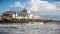 Bournemouth Pier Theatre with surfers in front in Bournemouth, Dorset, UK