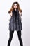 Boutique luxury fur. Winter fashion concept. Silver fur vest fashionable clothing. Girl makeup face long hairstyle wear