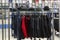 A boutique with men`s clothing on hangers. Shirts, jackets, caps. Style and fashion. Blurred