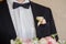 Boutonniere on trendy groom at wedding