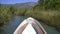 Bow Of Boat Advancing in Narrow River Surrounded By Reeds