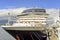 Bow of the cruise ship moored at the quay of a modern seaside ci