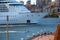 Bow of the large cruise ship driving over the bay and the embankment, Harbour Bridge