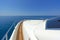 Bow of a luxury motor yacht cruising the blue sea.