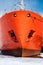 The bow of the marine vessel is orange with an anchor