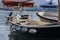 Bow of an old boat with peeling paint that floats on water on pier, swimming on waves, side view, close up