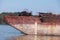 Bow of a rusty barge at Danube river on a sunny day