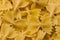 Bow tie pasta Close up. Farfalle pasta. Farfalle bows italian pasta. Farfalle - bow shaped pasta