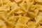 Bow tie pasta Close up. Farfalle pasta. Farfalle bows italian pasta. Farfalle - bow shaped pasta