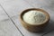 Bowl of agar-agar powder on tiled table, closeup