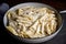 bowl of alfredo sauce and penne, ready for tossing