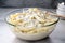 bowl of alfredo sauce and penne, ready for tossing