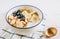 Bowl with amaranth corn pads with banana, blueberry and yogurt on white wooden background. Healthy breakfast and gluten free