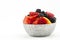 Bowl of antioxidant fruits piled with berries and melons