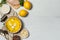 A bowl of avgolemono chicken soup, with meatballs. Flatlay on a gray wooden table. With food for cooking, horizontally