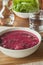 Bowl of Beet and Vegetable Soup with Salad