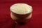 Bowl of Bengali sweet curd isolated on red background