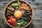 Bowl of bibimbap on the wooden table