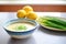 bowl of bisque with side of lemon and chives