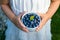 Bowl with blueberries in child hands