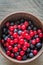 Bowl of blueberries with redcurrant on the wooden table