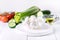 Bowl of Bocconcini Mozzarella Fresh Tomatoes Cucumber Celery Olive Oil Italian Salad Healthy Food White Background